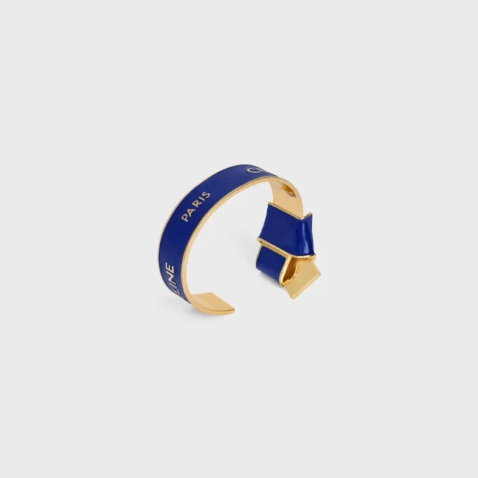 CELINE-armband met geknoopte strik van email en messing met gouden afwerking