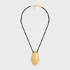 CELINE Dafila schelpenketting van messing met gouden afwerking en zijde