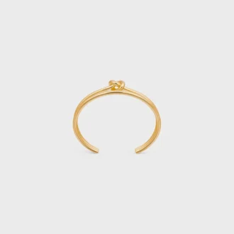 Dubbele manchet met knoop in messing met gouden afwerking