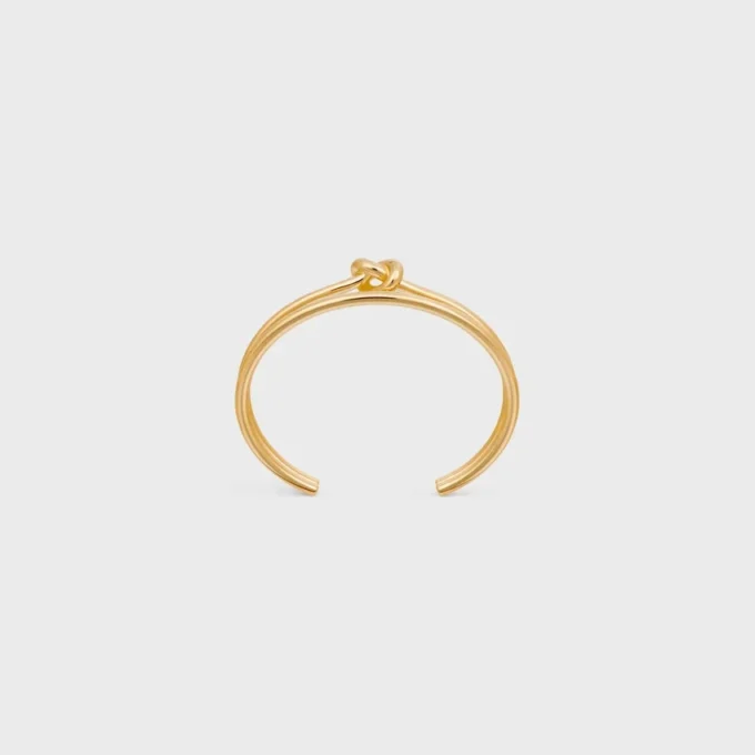 Dubbele manchet met knoop in messing met gouden afwerking