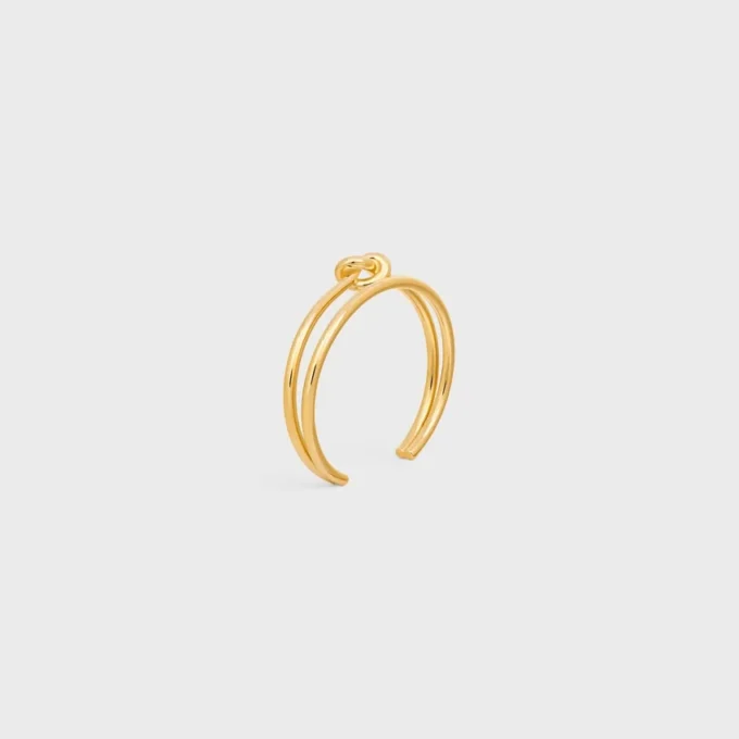 Dubbele manchet met knoop in messing met gouden afwerking
