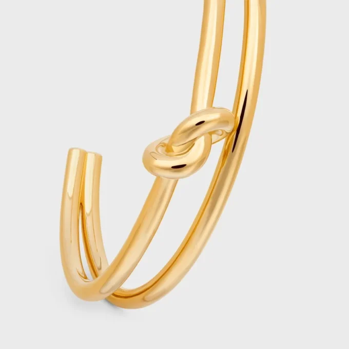 Dubbele manchet met knoop in messing met gouden afwerking