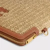 Kleine etui met riem van textiel met raffia-effect en kalfsleer