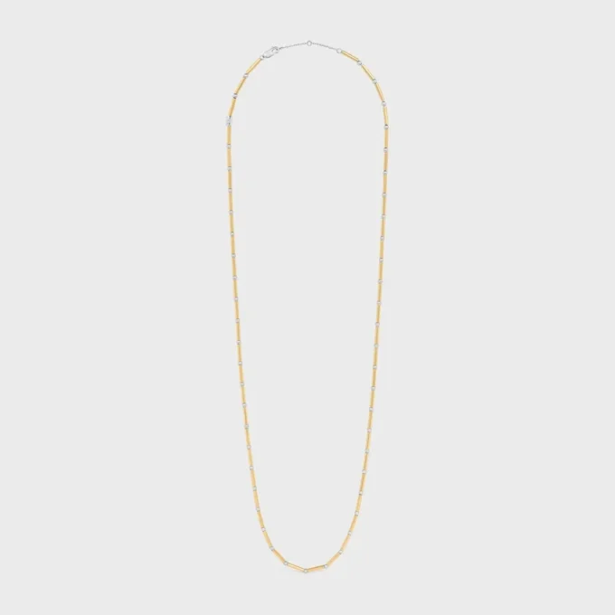 Lange ketting met bedels van messing met goud- en rhodiumafwerking
