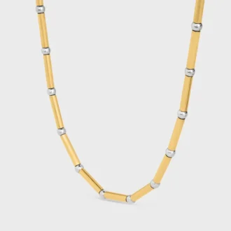 Lange ketting met bedels van messing met goud- en rhodiumafwerking