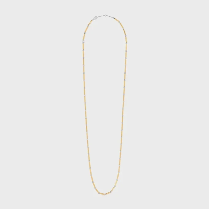 Lange ketting met bedels van messing met goud- en rhodiumafwerking