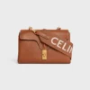 Lange riem van wol met CELINE-jacquard en gouden afwerking