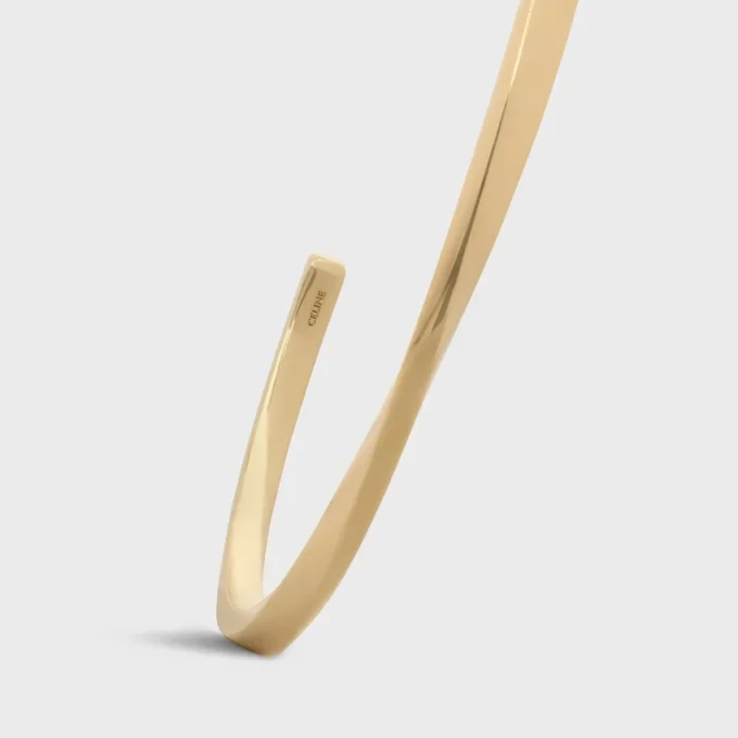 Torsiearmband in geelgoud