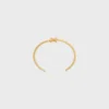 Triomphe asymmetrische manchet in messing met gouden afwerking