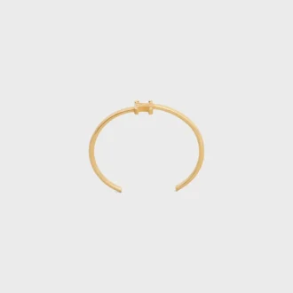 Triomphe asymmetrische manchet in messing met gouden afwerking