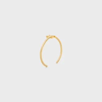 Triomphe asymmetrische manchet in messing met gouden afwerking
