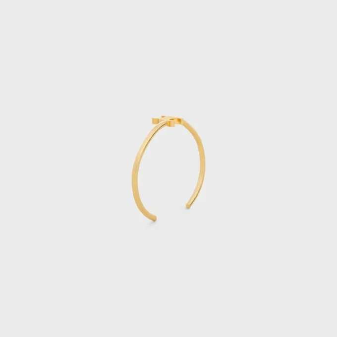 Triomphe asymmetrische manchet in messing met gouden afwerking