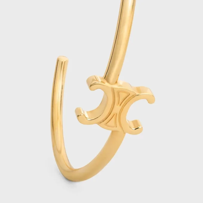 Triomphe asymmetrische manchet in messing met gouden afwerking
