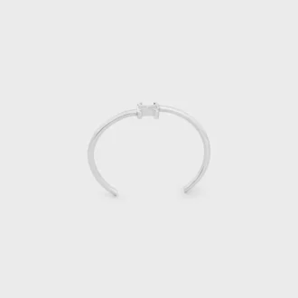 Triomphe asymmetrische manchet in messing met rhodiumafwerking