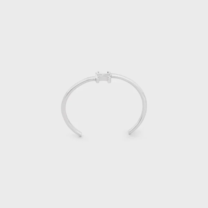 Triomphe asymmetrische manchet in messing met rhodiumafwerking