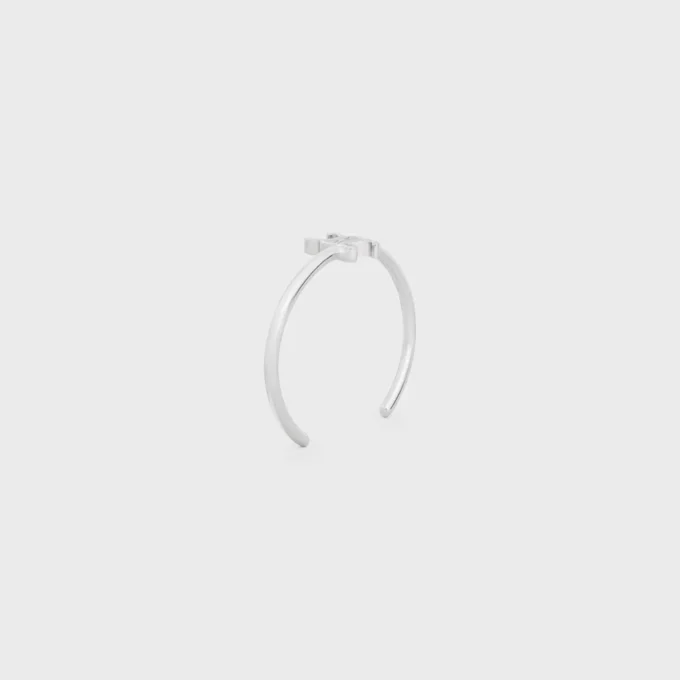 Triomphe asymmetrische manchet in messing met rhodiumafwerking