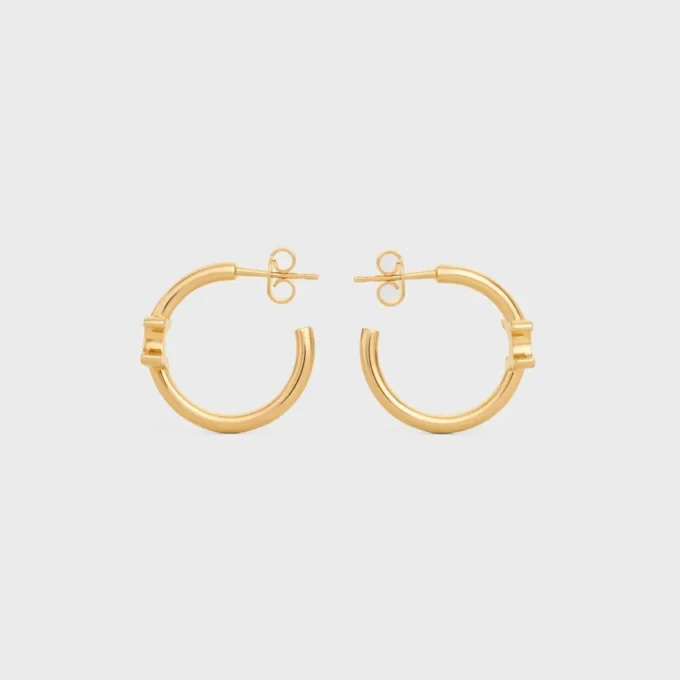 Triomphe asymmetrische oorringen van messing met gouden afwerking