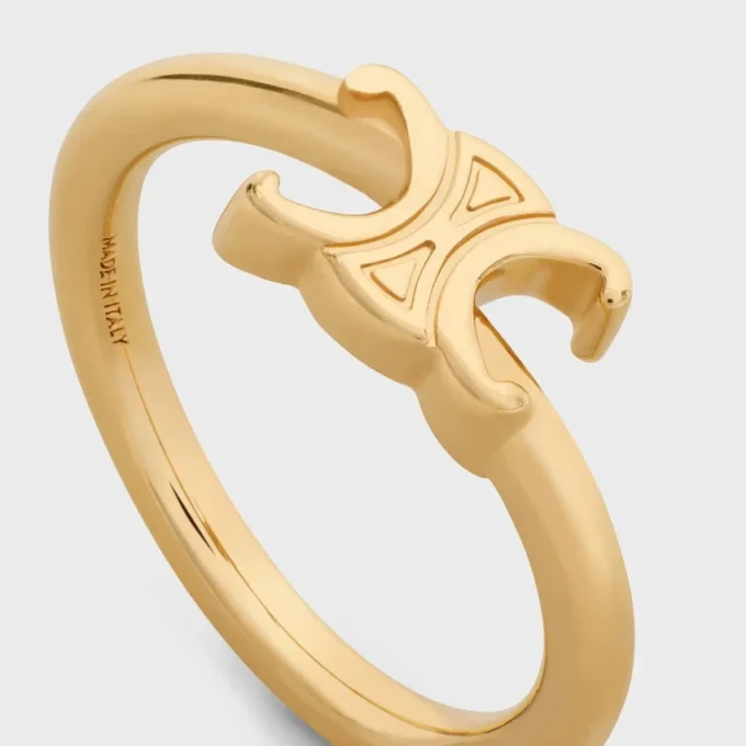 Triomphe asymmetrische ring van messing met gouden afwerking