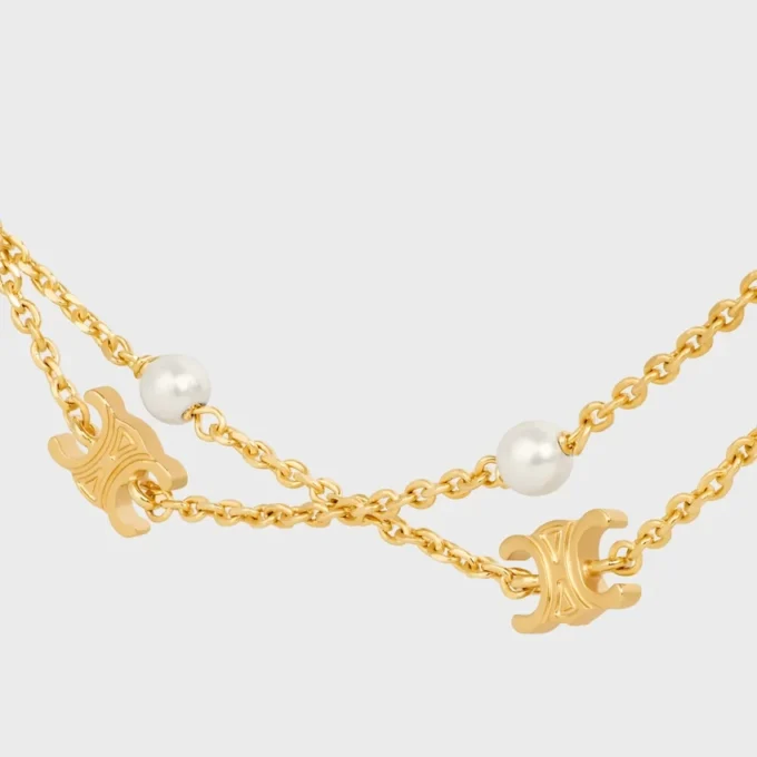 Triomphe Pearl dubbele ketting van messing met gouden afwerking en harsparels