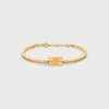 Triomphe scharnierende glinsterende armband van strass en messing met gouden afwerking