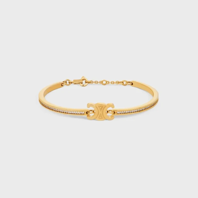 Triomphe scharnierende glinsterende armband van strass en messing met gouden afwerking